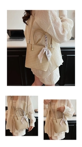 Detail of beige woven bucket bag with floral silk scarf and adjustable strap