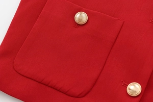Detailed shot of red woven texture with premium gold metallic buttons and pocket