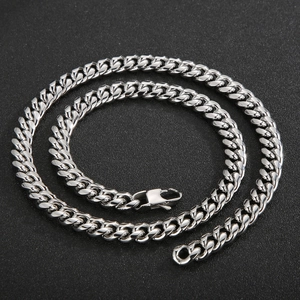 Macro shot of silver Cuban link chain with square clasp on black matte background