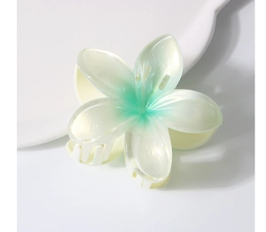 Macro shot of large pearlescent gradient plumeria flower claw clip with glossy resin finish