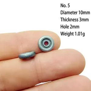Macro view of 10mm retro silver alloy flower spacer bead on finger for size scale