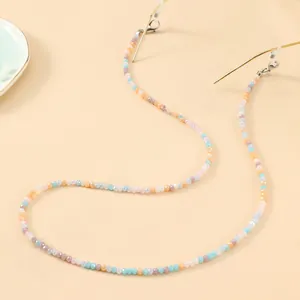 Detail of colorful beaded glasses chain with blue and purple beads and gold metal clips