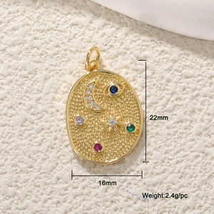 Detail view of gold oval pendant with celestial motifs and colorful zircons, 22mm by 16mm