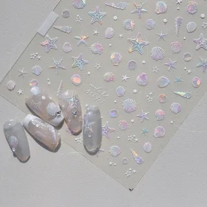 Close-up of shell-luster nail stickers with ocean patterns and holographic effects