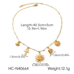 Detail view of gold charm necklace with sun, heart, shell and cross pendants and dimensions