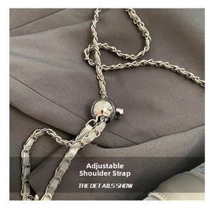 Detail of adjustable silver metal chain strap with a quilted sphere bead for mini bags