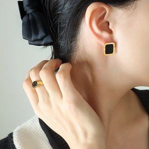 Rectangle Roman numeral earrings and gold smiley ring set on a fashion model