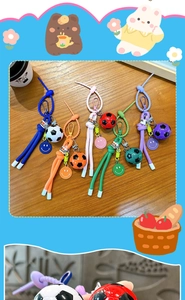 Detail of soccer ball keychains with woven ropes in blue, orange, pink, green, and purple