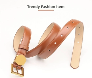 Detailed view of classic brown leather belt with gold metal buckle and circular ornament