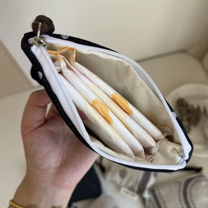 Internal view of polka dot canvas pouch storing daily sanitary napkins for organization