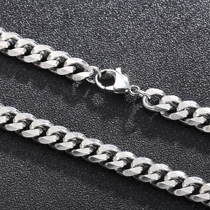 Macro shot of silver stainless steel Cuban chain link and secure lobster clasp closure