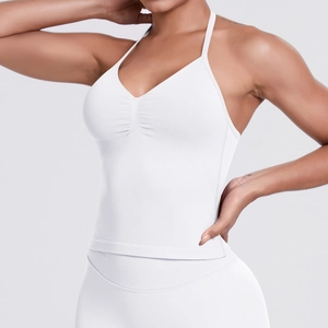 Detailed close-up of white halter neck sports bra with V-neck and ruched front design