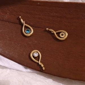 18K gold plated stainless steel teardrop pendants with colorful zircon stones on wood