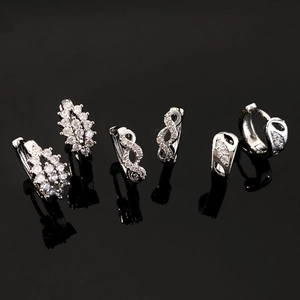 Three silver-tone copper drop earrings with cubic zirconia inlay and hollow vintage designs