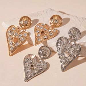 Exaggerated metal heart earrings with rhinestones and vintage hammered texture finish