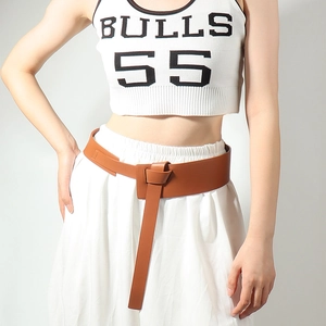 Close-up of brown PU leather wrap belt with stylish knot design on woman's dress