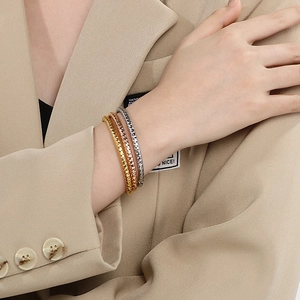 Three-piece textured twist bangle set in gold, rose gold, and silver for professional women