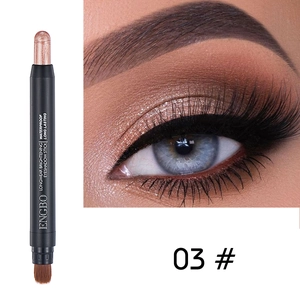 Detail view of dual-ended champagne gold eyeshadow stick with brush and makeup effect