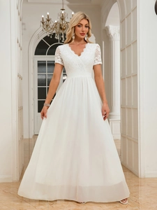 Detail of elegant V-neck bodice with floral lace texture on white chiffon gown
