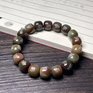 Macro detail of retro Bodhi root beads with Chinese characters and paw prints