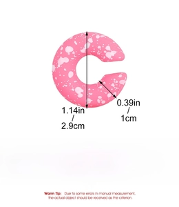 Detail showing 2.9cm diameter and 1cm thickness of pink C-shape acrylic earrings