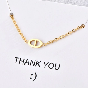 Elegant gold choker necklace featuring a stylish oval pig nose link on a fine chain