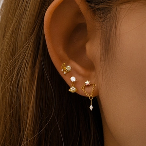 Detailed view of S925 silver gold moon and star stud earrings set with crystal stones