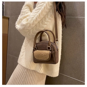 Detail of a brown plush crossbody bag with sherpa pocket and adjustable shoulder strap