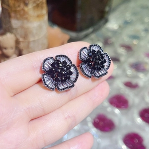 Macro view of camellia stud earring with black cubic zirconia and silver crystals