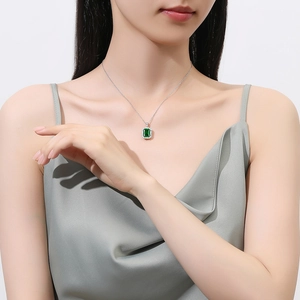 Elegant S925 silver necklace featuring a rectangular green emerald pendant on a female model