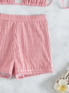 Detail of pink high-waisted bikini shorts with breathable textured knit fabric texture