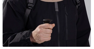 Detail of waterproof zipper and tear-resistant fabric on black outdoor jacket