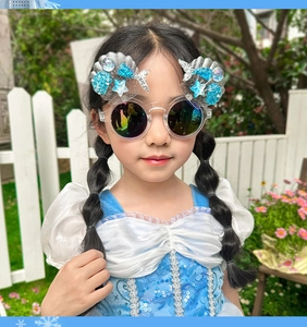 Close-up of pink shell and starfish decoration on girls' glitter princess sunglasses