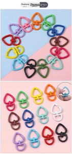 Macro detail of heart-shaped lobster clasps in various colors with swivel D-rings