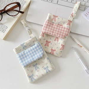 Floral nurse pocket organizer set with pastel checkered bow patterns in soft desk setup