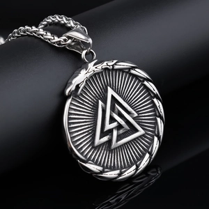 Detail view of Valknut Viking pendant with serpent relief on vintage silver chain