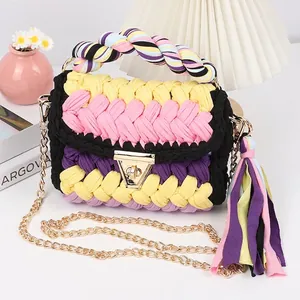 Detail of handmade crochet crossbody bag with colorful patchwork and oversized tassel