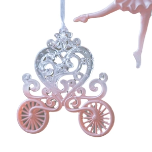 Pink heart carriage ornament hanging on white background for Christmas tree decoration