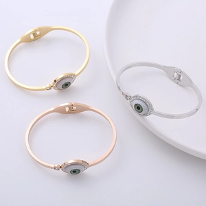 Three-piece stainless steel evil eye bangle set in gold, silver, and rose gold finishes