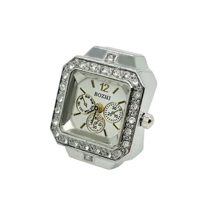 Silver square ring watch with crystal bezel and white dial showing decorative sub-dials