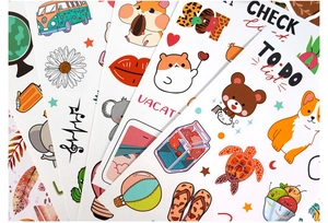 Close-up of bohemian DIY journal stickers featuring animals and decorative patterns