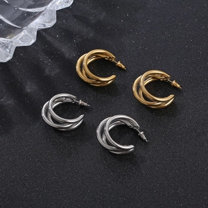 Set of gold and silver multi-layer C-shape stainless steel earrings on black background