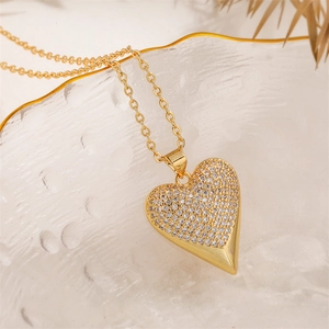Close-up of heart pendant with micro-paved cubic zirconia on textured glass surface