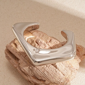 Detailed view of silver irregular geometric open cuff with mirror-polished finish