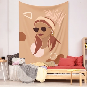 Detail view of Bohemian tapestry with female portrait hanging above a bed in a cozy bedroom