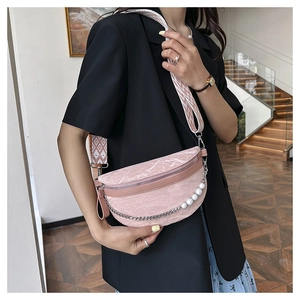 Detail of pink pleated crescent bag with pearl chain and geometric pattern strap