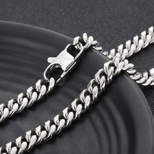Macro detail of silver titanium steel Cuban link chain necklace with lobster clasp