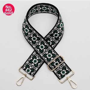 Detail of ethnic geometric woven bag strap with golden metal hooks and buckles