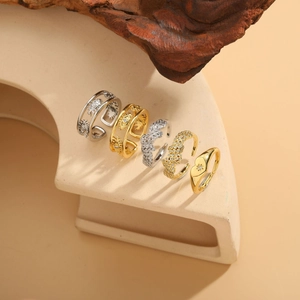 Detailed close-up of mixed gold and silver rings with evil eye and heart motifs