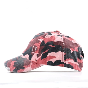 Detail of distressed pink camouflage ponytail baseball cap with vintage frayed edges